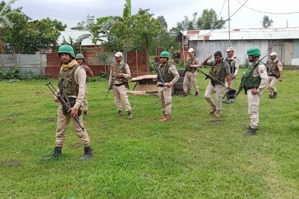 Security personnel patrolling a residential area in Manipur